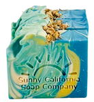 Soap bar swirled in blue, yellow and white with dried chamomile flowers on top. 