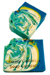 Soap bar swirled in blue, yellow and white with dried chamomile flowers on top.