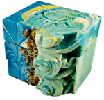 Soap bar swirled in blue, yellow and white with dried chamomile flowers on top.