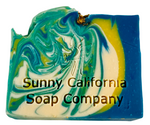 Soap bar swirled in blue, yellow and white with dried chamomile flowers on top.